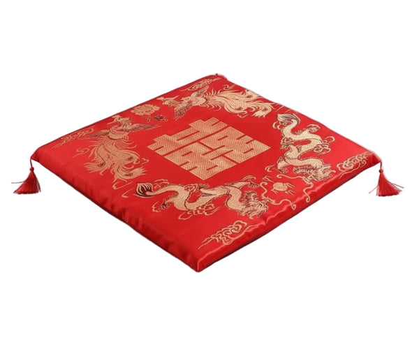 Red fabric with gold dragon design and double happiness symbol on a red background