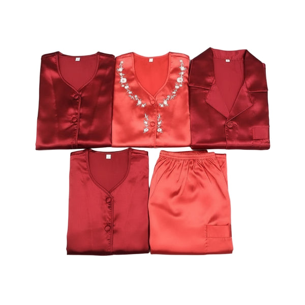 Set of red satin garments with floral embroidery on a dark background